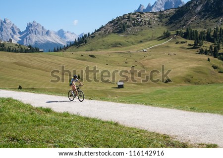 Mountain biking - woman on bike, Dolomites, Italy