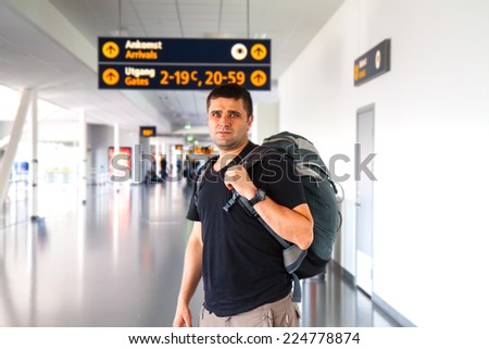 young sporty man in airport. Tourist man with backpack in landing zone.
