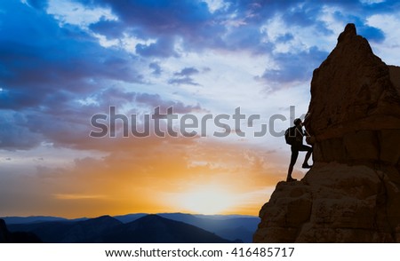 silhouette of successful climbing woman in mountains Concept of motion motivation inspiration at beautiful sunset
