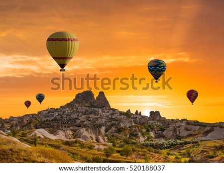 Colorful hot air balloons flying over the valley at Cappadocia, Uchisar, Turkey. Volcanic mountains in Goreme national park