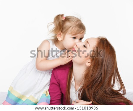 Happy Woman And Young Girl (Child) In Bed Smiling. Mother Day Concept