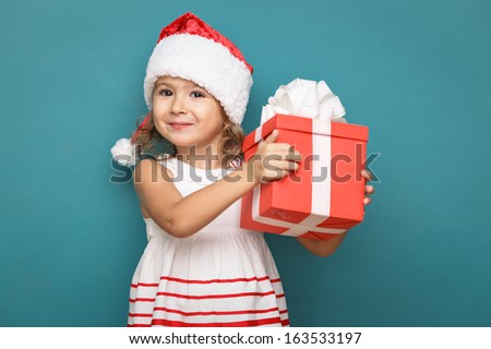 Happy Little Smiling Girl With Christmas Gift Box.