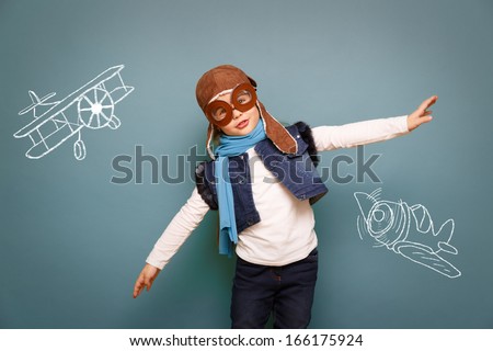 Beautiful Smiling Child (Girl) In Helmet On A Green Background. Vintage Pilot (Aviator) Concept