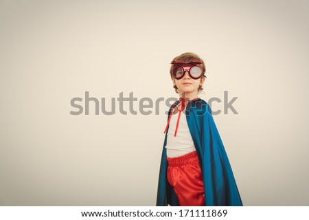 Funny Little Power Super Hero Child (Boy) In A Blue Raincoat. Superhero Concept