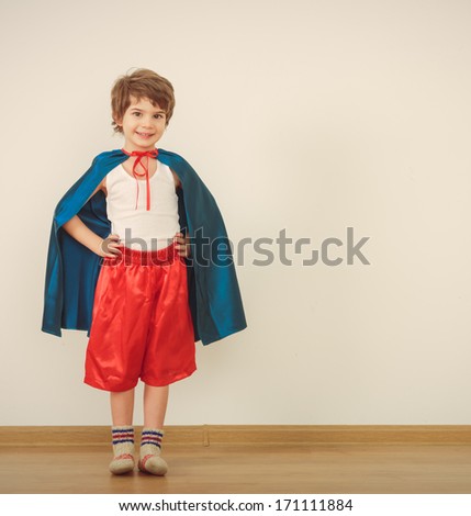 Funny Little Power Super Hero Child (Boy) In A Blue Raincoat. Superhero Concept