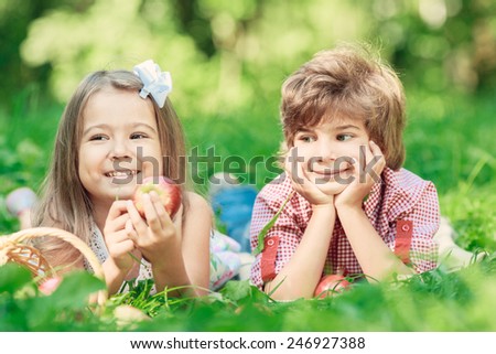 Happy smiling children playing outdoors in spring park. Picnic concept