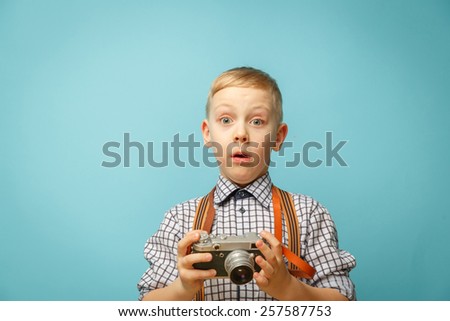 Beautiful smiling child (kid, boy) - photographer holding a instant camera