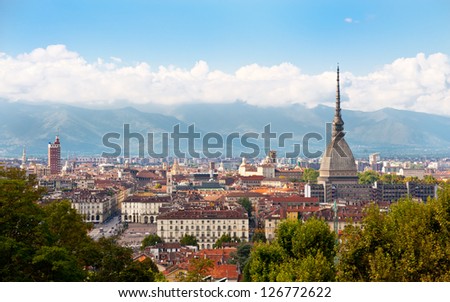 Cityscape of Turin (Italy) featuring the Mole Antonelliana and the Alps in the background.