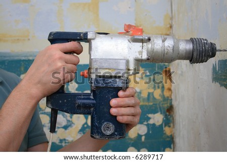 working with a power drill in a house