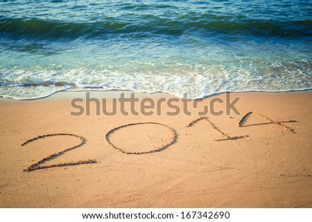 Writing Happy New Year\'s 2014 on the Beach in Thailand