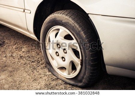 Close up Flat tire and old car on the road waiting for repair