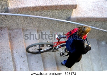 a girl walking down the stairs with bicycle