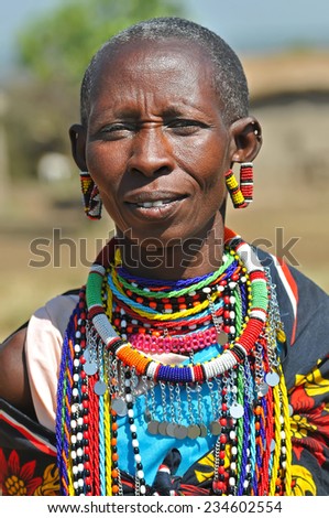 MAASAI MARA, KENYA - AUGUST 12: Maasai Woman in the village, 12 August, 2010 at Masaai Mara, Kenya. The Maasai are the most famous tribe in Africa. They are nomadic and live in small villages.
