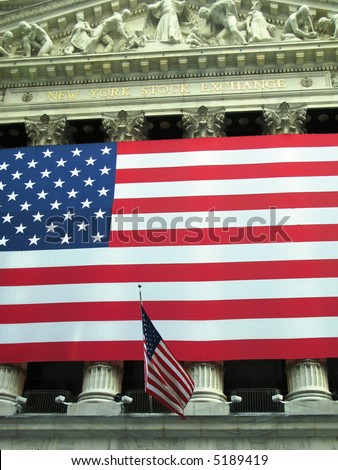 View of New York Stock Exchange facade draped with American flag. (New York City)