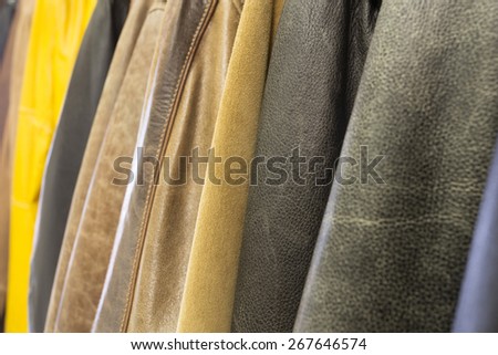 hanging a lot of multicolored leather jackets under repair