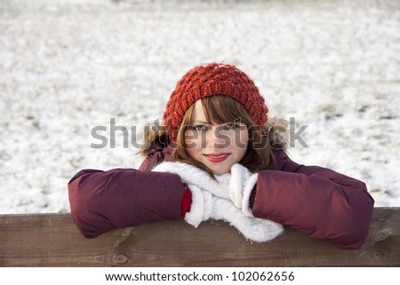 Portrait of cute girl in hat and gloves in winter