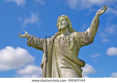 Pre 1900 statue of Jesus with arms reaching up to heavens from a grave in the famous landmark Milltown Cemetery Belfast, which is the largest Catholic burial ground in Belfast and synonymous with Ir