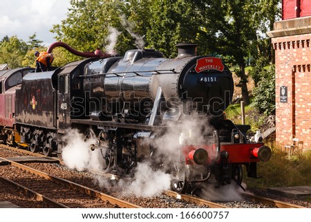 APPLEBY, ENGLAND - AUGUST 18:  Preserved Stanier Class 8F steam locomotive number 48151 takes on water in Appleby, England on August 18, 2013, on the Settle to Carlisle railway.