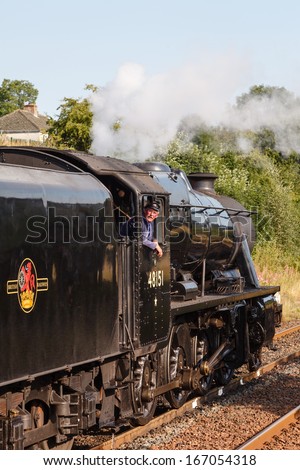 APPLEBY, ENGLAND - AUGUST 25:  The train driver aboard preserved Stanier Class 8F steam locomotive number 48151 waits to depart Appleby, England on August 25, 2013, on the Settle to Carlisle railway.