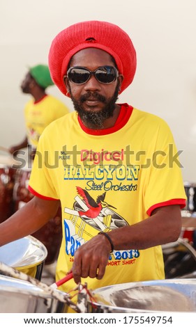 ST JOHNS, ANTIGUA - NOVEMBER 6:  The Halcyon Steel Orchestra perform on the St Johns quayside in Antigua on November 6, 2013.  The steel drum originates from Trinidad and Tobago in the West Indies.
