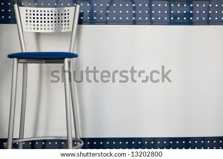 Metal bar chair with square holes. Modern background.