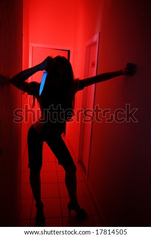 Silhouette of woman with knife in some corridor