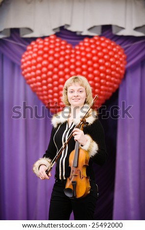 Smiling woman with violin at a concert