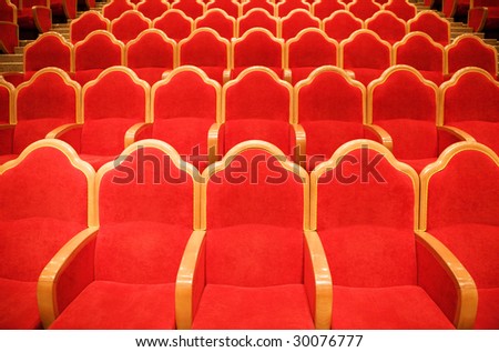 Red chairs in some theater
