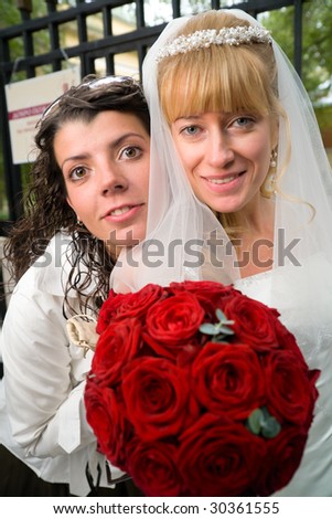  Portrait of a bride holding a small wedding bouquet of red roses and