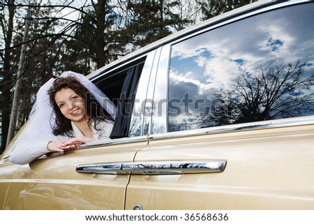 Happy bride in rich car