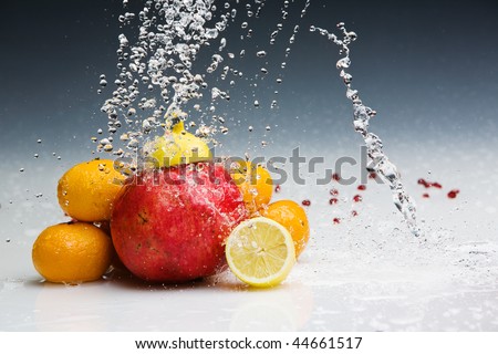 Studio shot of various fruits with water splashes frozen by Broncolor Grafit A4