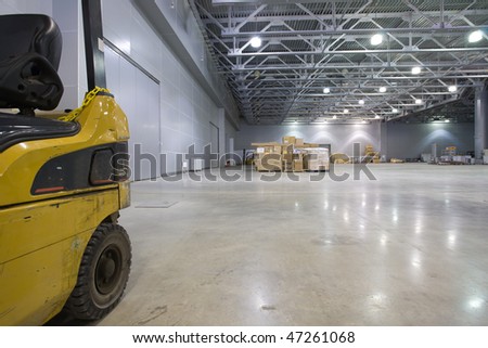 Loader in  large modern storehouse