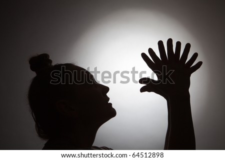 Silhouette of woman and her hands in form of a cock