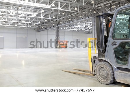 Forklift loader in large modern storehouse