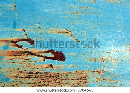 A blue sheet of metal covered in varying degrees of rust