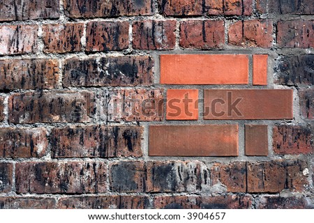 Brand New Bricks repairing an old brick wall