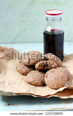 Chocolate chips oatmeal cookies and bottle of cherry juice