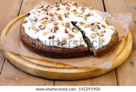 Carrot and courgette cake with nuts and raisin, with yogurt frosting