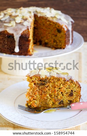 Carrot cake with icing and almond slices