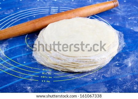 Dough discs rolled for flatbread in cling film