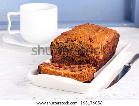 Slice of fruit and rum cake and cup of tea