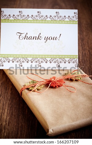 Gift wrapped in brown paper and card with words: thank you