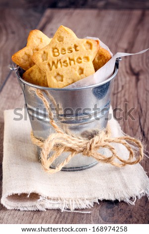 Stamp cookies with words best wishes in a tiny bucket