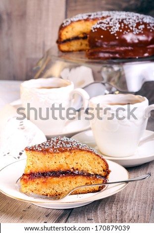 Layer spicy cake with jam and chocolate glaze