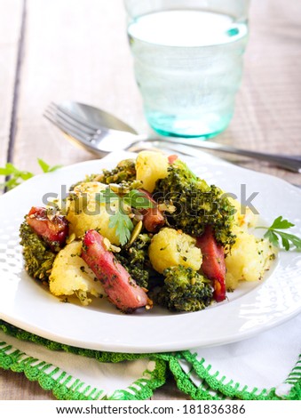 Broccoli and cauliflower fried with bacon and seeds