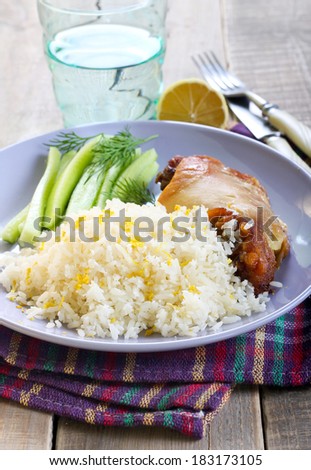 Lemon and coconut rice with chicken on plate