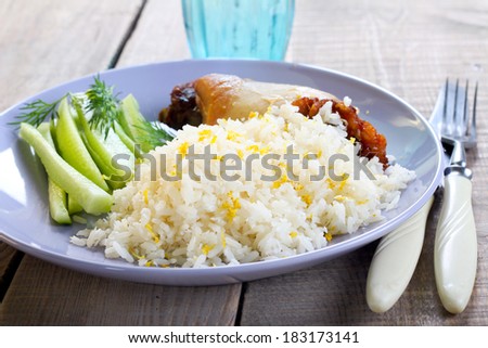Lemon and coconut rice with chicken on plate