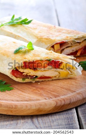 Wrap sandwich with chicken, cheese and tomato filling