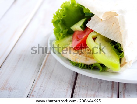 tortilla wrap with chicken and vegetables, selective focus