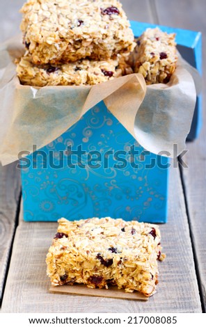 Oat bars with cranberry, nuts and seeds in a box